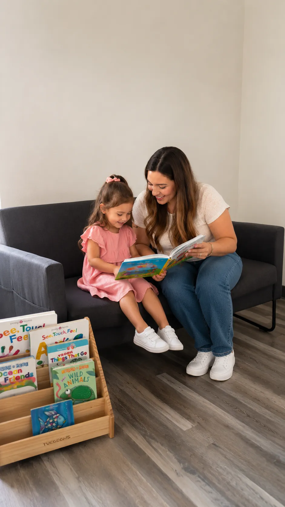 A mother reading a picture book with her daughter in the Fun Together cozy book corner